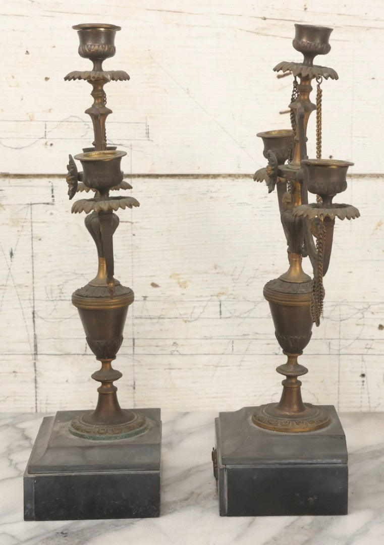 Lot 018 - Pair Of Antique Brass Three-Arm Candelabras With Floral Rosettes, Chains, And Ornate Ornamentation On Black Slate Bases, Circa 1850, 13-1/2" H Each