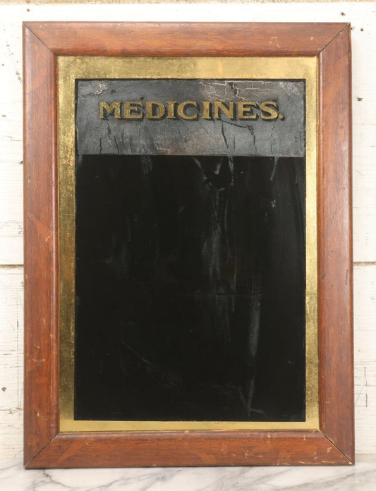 Lot 038 - Antique Reverse-Painted Glass Sign Panel Reading "Medicines." With Black Display Field And Gold Leaf Border, Possibly For Apothecary Or Doctor's Office, Framed, 14-1/4" x 19-1/4"