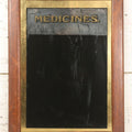 Lot 038 - Antique Reverse-Painted Glass Sign Panel Reading "Medicines." With Black Display Field And Gold Leaf Border, Possibly For Apothecary Or Doctor's Office, Framed, 14-1/4" x 19-1/4"