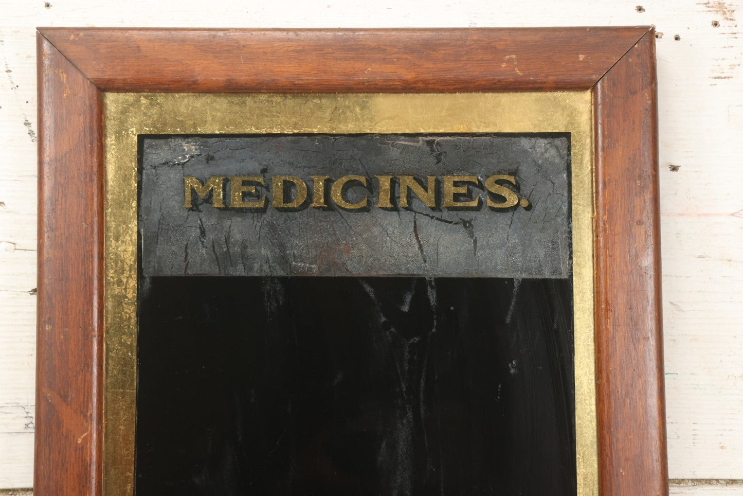 Lot 038 - Antique Reverse-Painted Glass Sign Panel Reading "Medicines." With Black Display Field And Gold Leaf Border, Possibly For Apothecary Or Doctor's Office, Framed, 14-1/4" x 19-1/4"