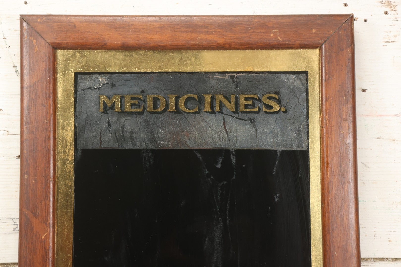 Lot 038 - Antique Reverse-Painted Glass Sign Panel Reading "Medicines." With Black Display Field And Gold Leaf Border, Possibly For Apothecary Or Doctor's Office, Framed, 14-1/4" x 19-1/4"
