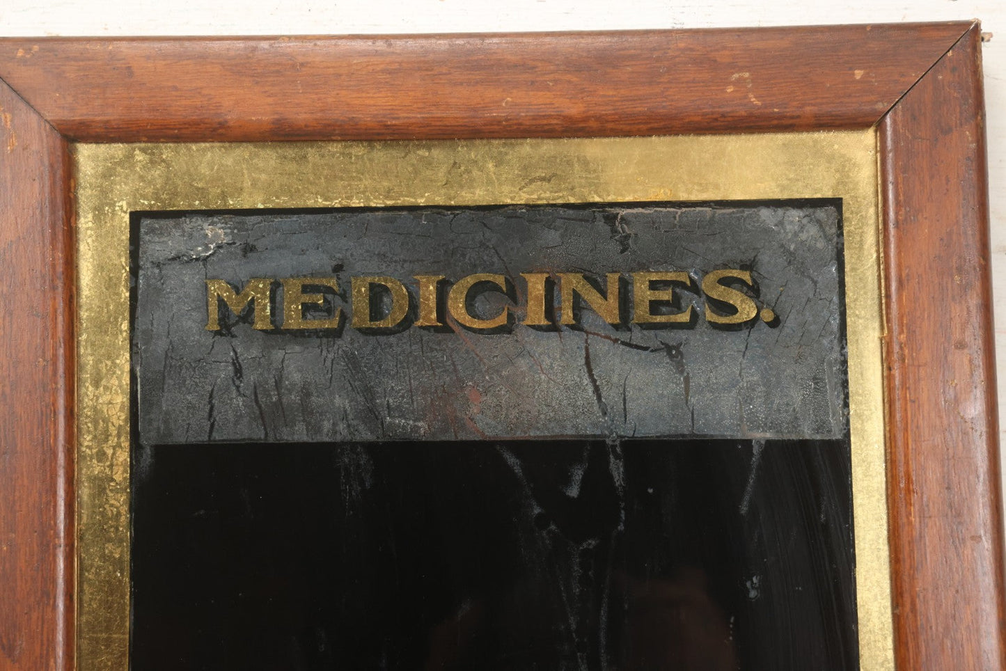 Lot 038 - Antique Reverse-Painted Glass Sign Panel Reading "Medicines." With Black Display Field And Gold Leaf Border, Possibly For Apothecary Or Doctor's Office, Framed, 14-1/4" x 19-1/4"