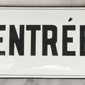 Lot 040 - Antique Convex Porcelain Sign “Entrée” (French, "Entrance") With Black Letters On White Field And Black Pinstripe Border, Attributed To Édouard Busath, Brussels, Belgium, 5-1/2" x 2-3/4"
