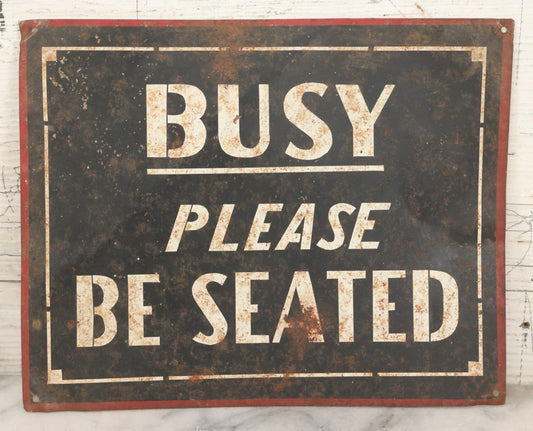 Lot 041 - Vintage Stenciled Tin Sign Reading "Busy — Please Be Seated," Black Field With White Lettering And Red Border, 10" x 8"