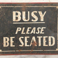 Lot 041 - Vintage Stenciled Tin Sign Reading "Busy — Please Be Seated," Black Field With White Lettering And Red Border, 10" x 8"