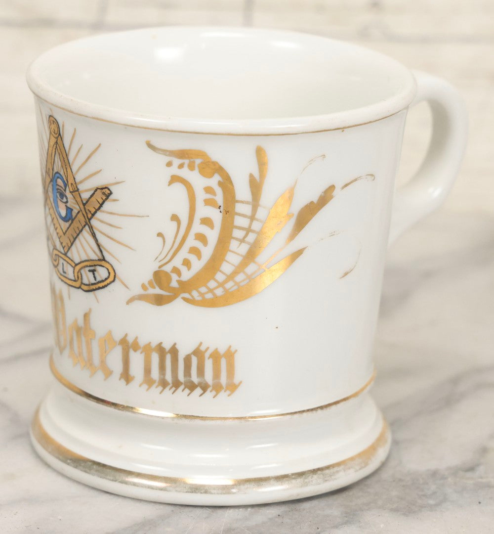 Lot 047 - Antique Hand-Decorated Porcelain Mug With Masonic Compass And Square, All-Seeing Eye, And Odd Fellows Three-Link F.L.T. Emblems, Belonging To V.E. Waterman, With Gold Painted Accents, T&V Limoges, France, 3-5/8" H