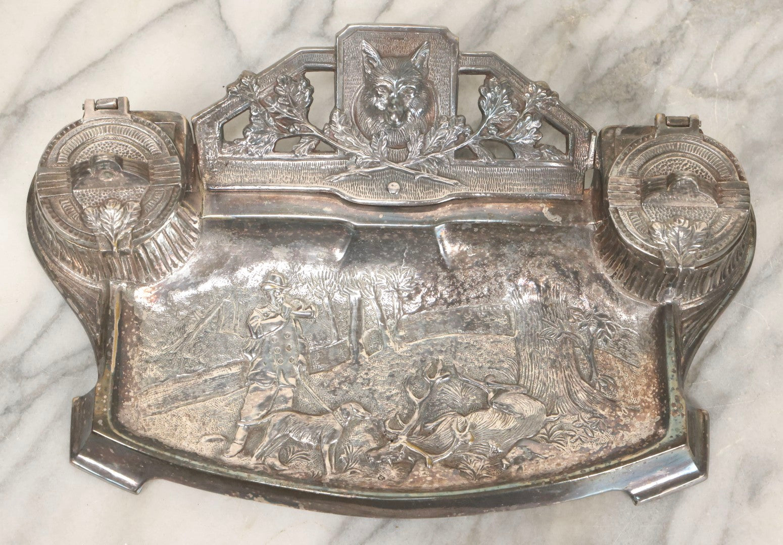 Lot 052 - Antique Cast Iron Double Inkwell With Chrome Finish Depicting Fox Head, Oak Branches, And English Hunting Scene With Hunter, Dog, And Stag, Stamped L.P., Circa Early 20th Century