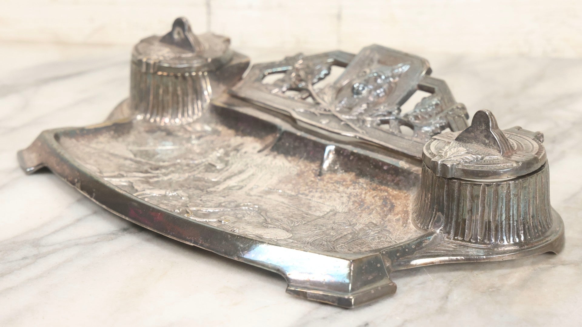 Lot 052 - Antique Cast Iron Double Inkwell With Chrome Finish Depicting Fox Head, Oak Branches, And English Hunting Scene With Hunter, Dog, And Stag, Stamped L.P., Circa Early 20th Century