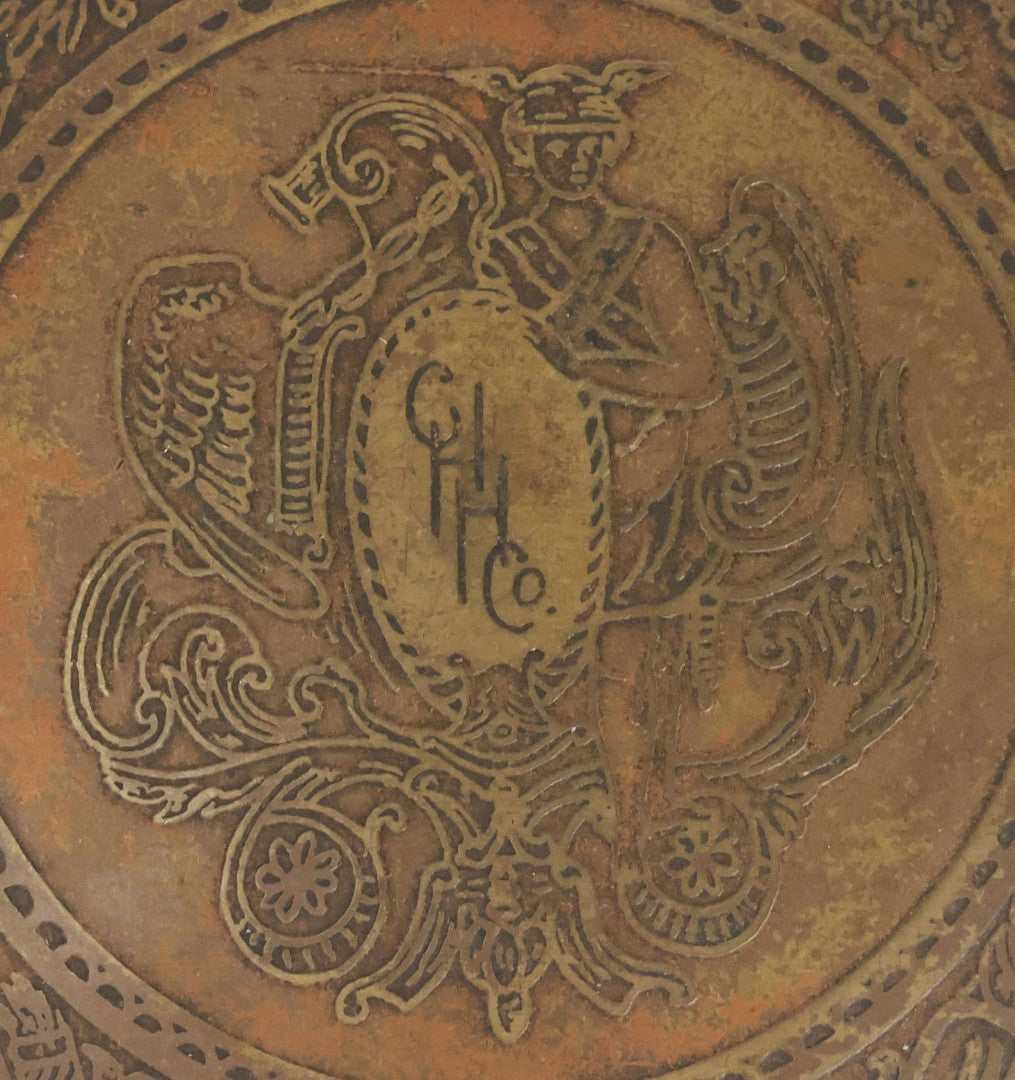 Lot 063 - Antique 1921 C. H. Hanson Co. Chicago Brass Advertising Paperweight With Ornate Crest And Motto "Handsome Is What Hanson Does," 3-3/8" Diameter