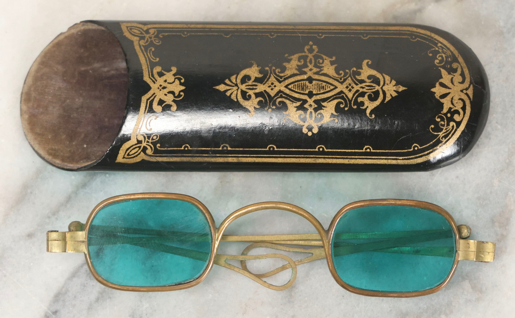 Lot 065 - Antique Brass Frame Eyeglasses With Blue-Green Tinted Lenses And Folding Side Extensions, In Black Lacquered Papier-Mâché Case With Gilt Detailing