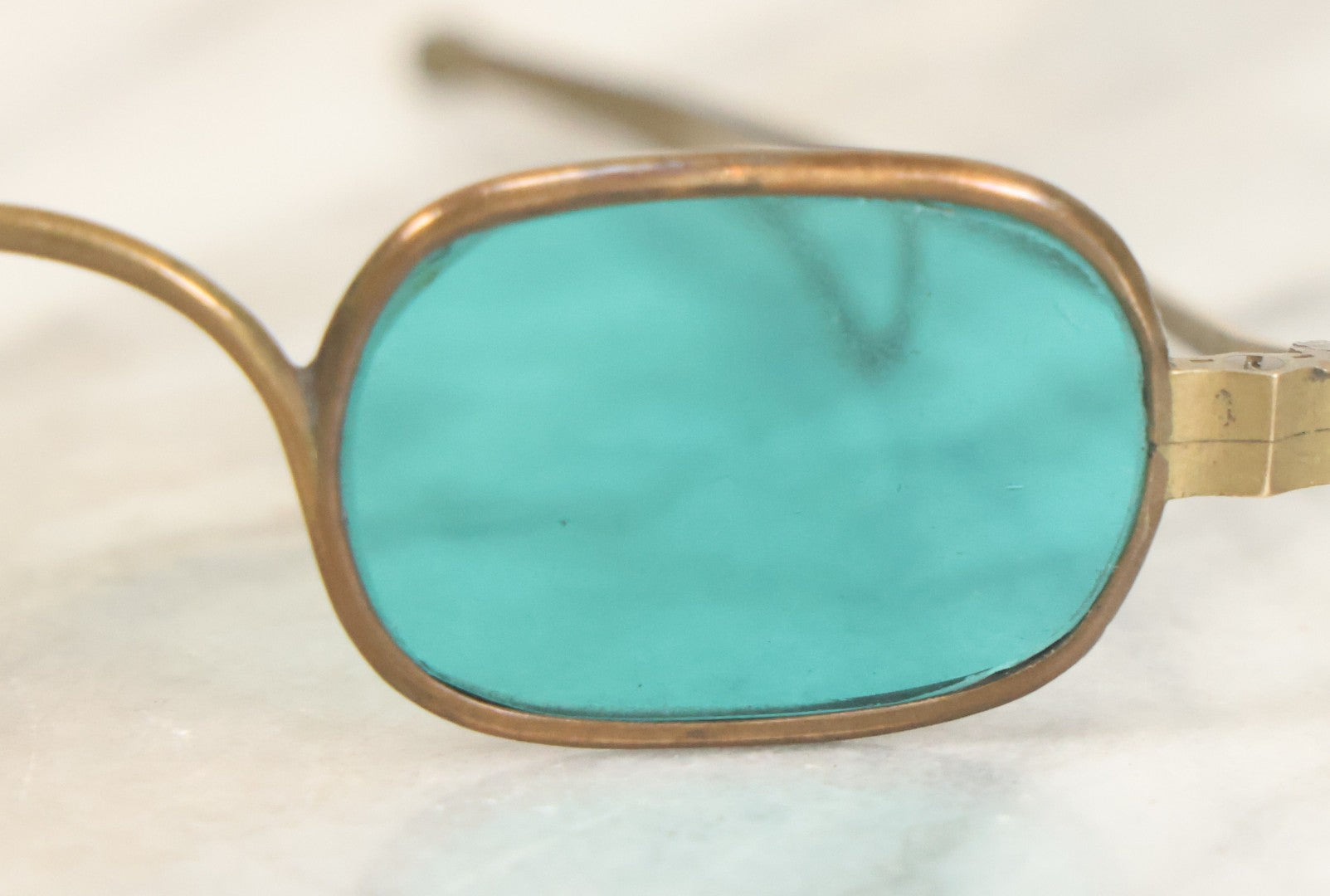 Lot 065 - Antique Brass Frame Eyeglasses With Blue-Green Tinted Lenses And Folding Side Extensions, In Black Lacquered Papier-Mâché Case With Gilt Detailing