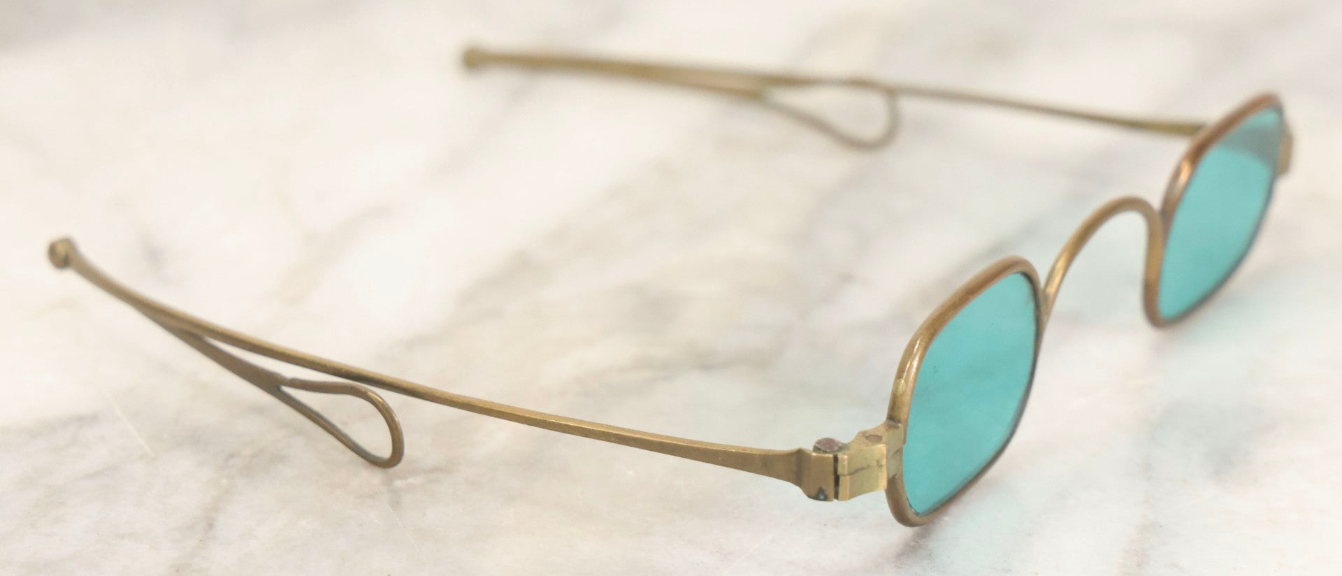Lot 065 - Antique Brass Frame Eyeglasses With Blue-Green Tinted Lenses And Folding Side Extensions, In Black Lacquered Papier-Mâché Case With Gilt Detailing