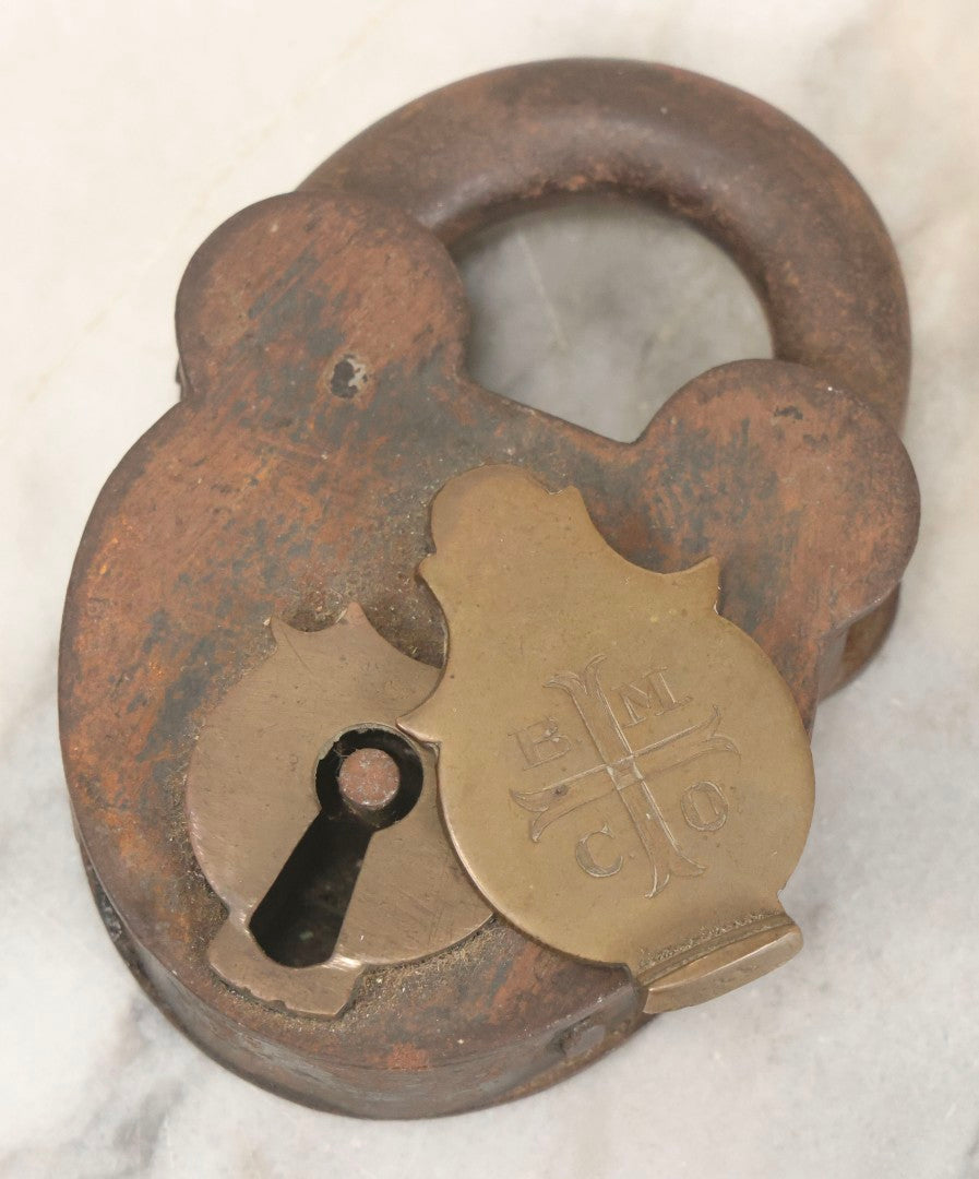 Lot 072 - Antique Cast Iron And Brass Padlock Marked “B.M.Co.” With Cross Motif On Brass Cover, Unlocked, No Key