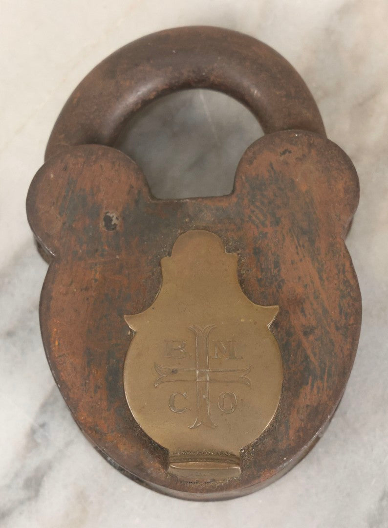 Lot 072 - Antique Cast Iron And Brass Padlock Marked “B.M.Co.” With Cross Motif On Brass Cover, Unlocked, No Key