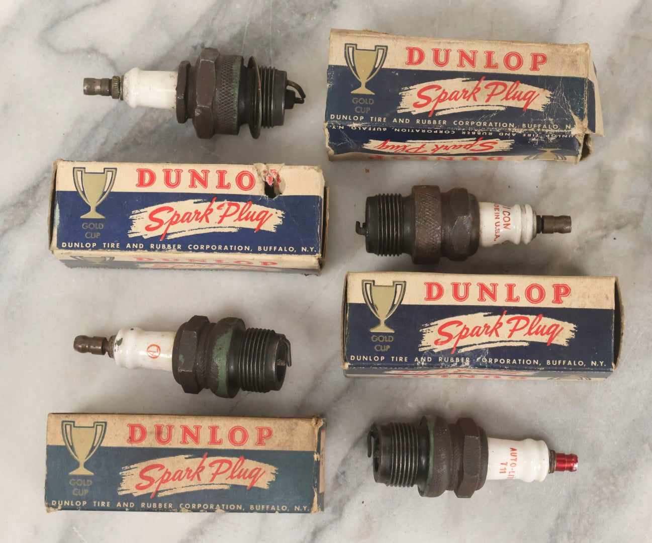 Lot 075 - Grouping Of Mixed Vintage Spark Plugs And Empty Dunlop Spark Plug Boxes Including Champion And Autolite Examples
