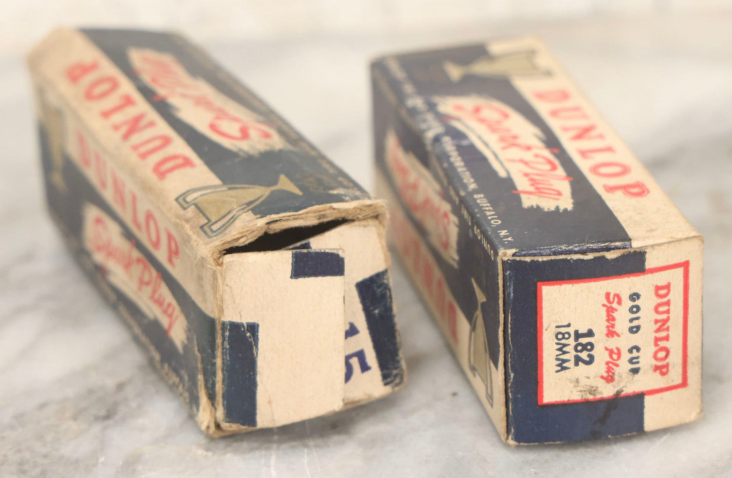 Lot 075 - Grouping Of Mixed Vintage Spark Plugs And Empty Dunlop Spark Plug Boxes Including Champion And Autolite Examples
