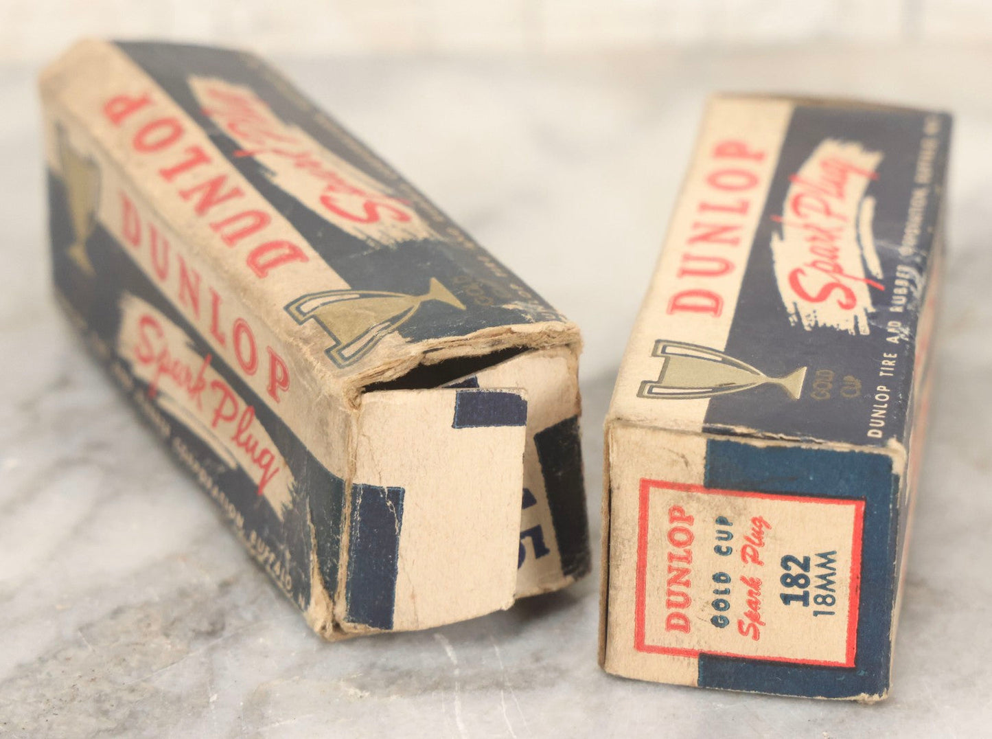 Lot 075 - Grouping Of Mixed Vintage Spark Plugs And Empty Dunlop Spark Plug Boxes Including Champion And Autolite Examples