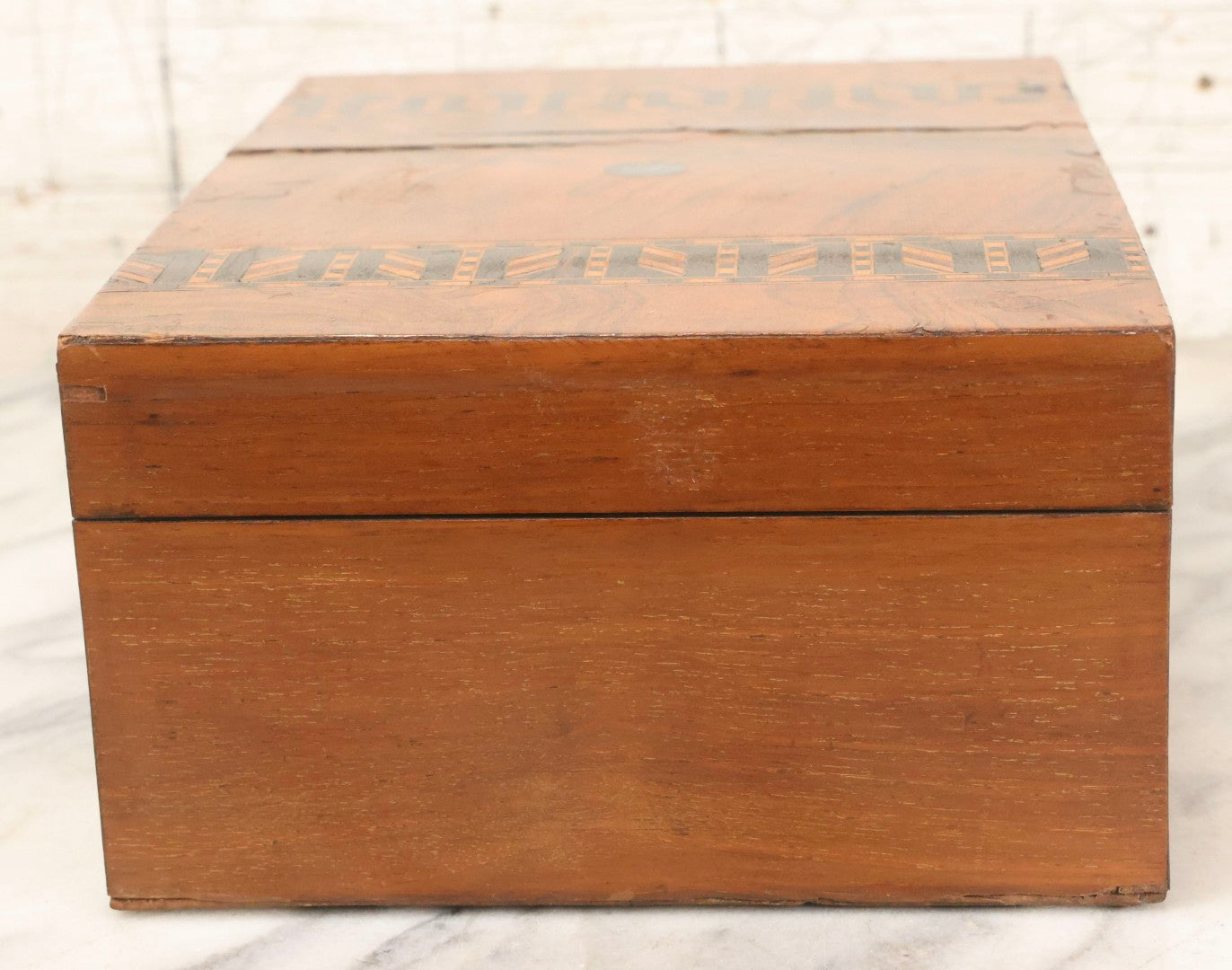 Lot 077 - Antique Burlwood Veneered Wooden Document Box With Inlaid Geometric Patterned Stripes And Center Metal Pendant