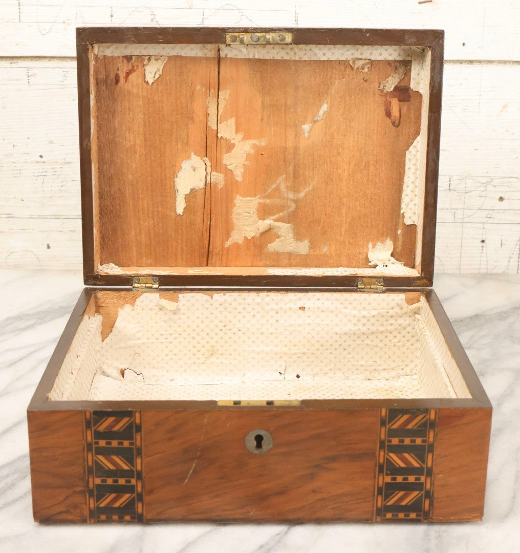 Lot 077 - Antique Burlwood Veneered Wooden Document Box With Inlaid Geometric Patterned Stripes And Center Metal Pendant