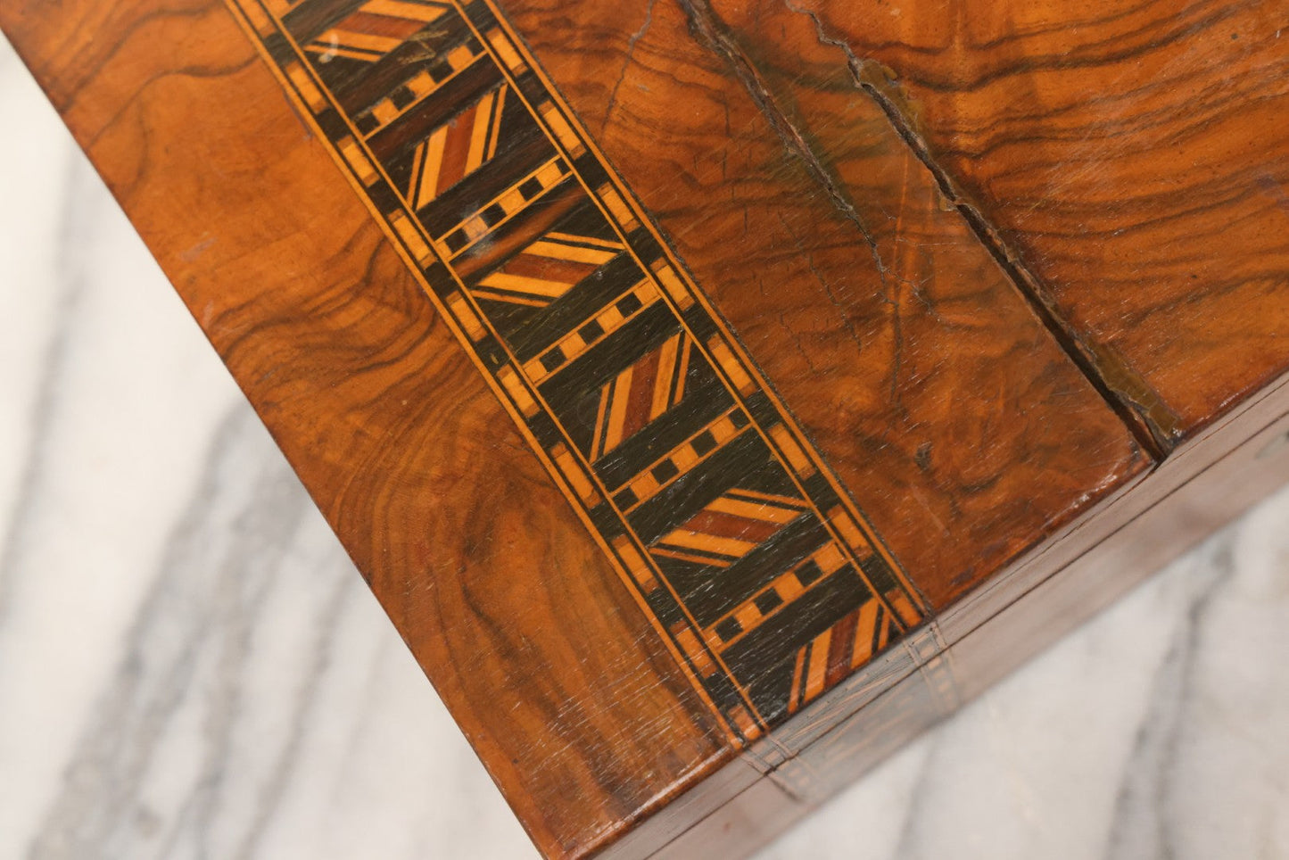 Lot 077 - Antique Burlwood Veneered Wooden Document Box With Inlaid Geometric Patterned Stripes And Center Metal Pendant