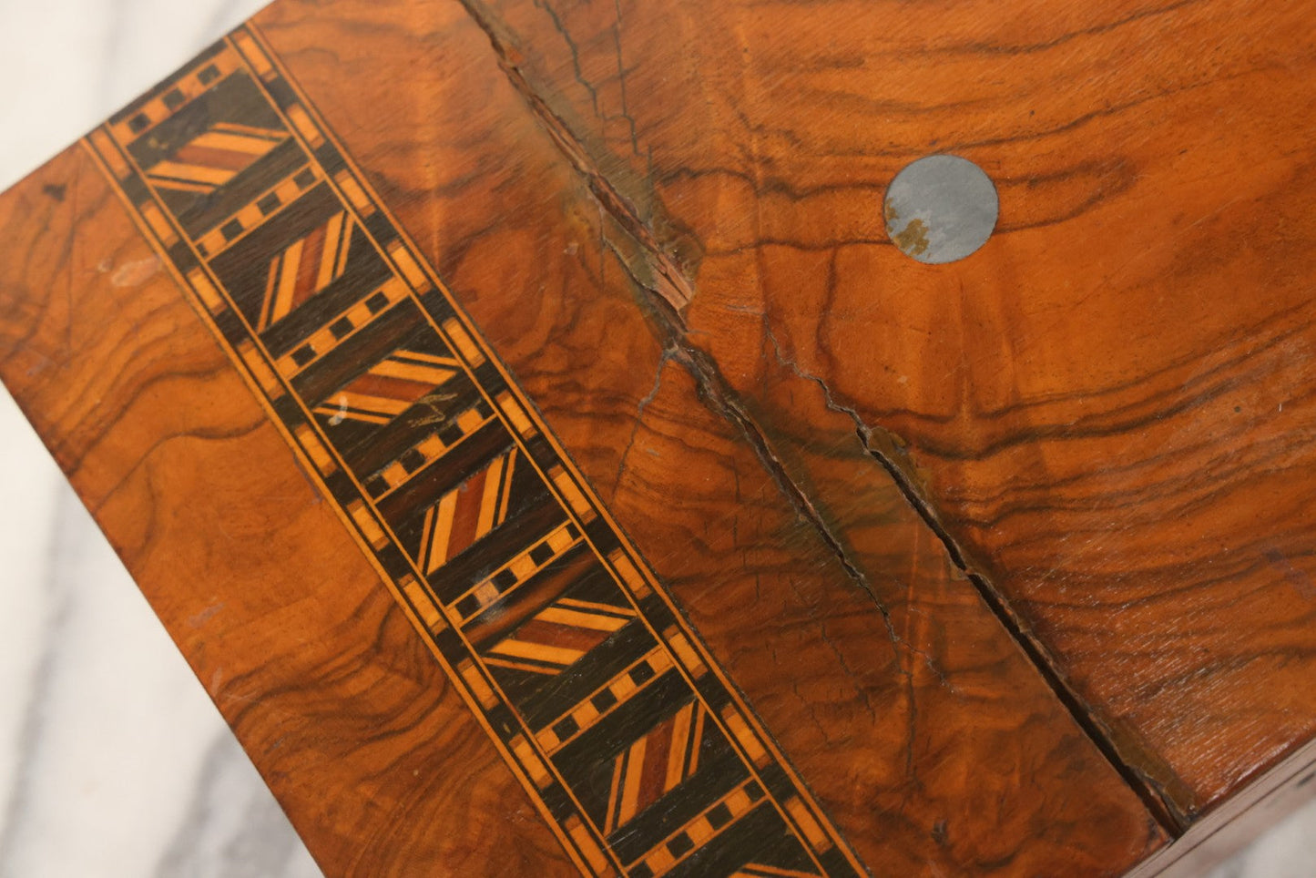 Lot 077 - Antique Burlwood Veneered Wooden Document Box With Inlaid Geometric Patterned Stripes And Center Metal Pendant