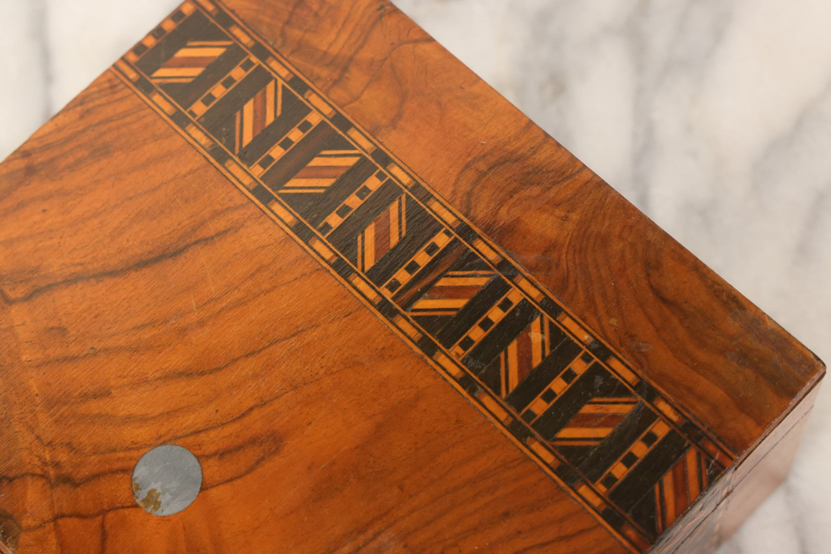 Lot 077 - Antique Burlwood Veneered Wooden Document Box With Inlaid Geometric Patterned Stripes And Center Metal Pendant