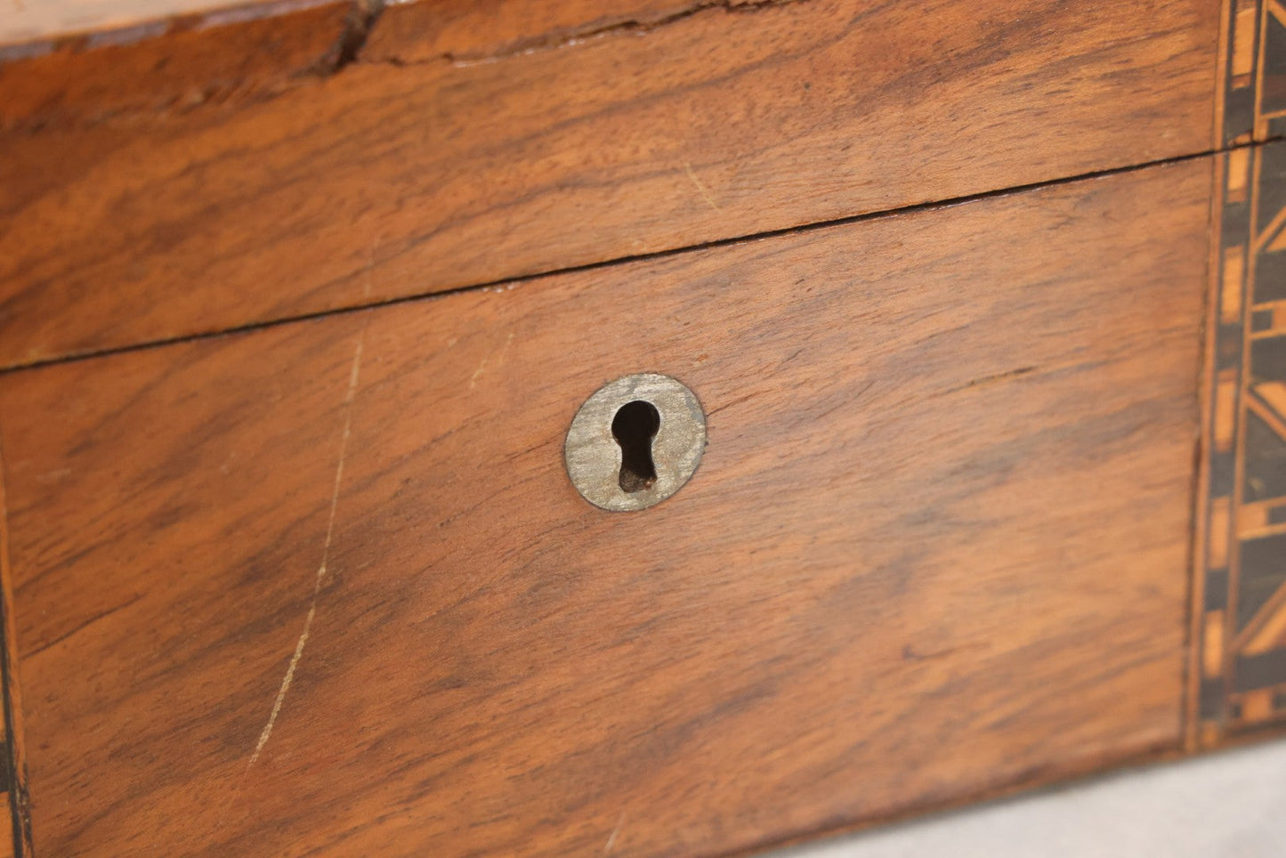Lot 077 - Antique Burlwood Veneered Wooden Document Box With Inlaid Geometric Patterned Stripes And Center Metal Pendant