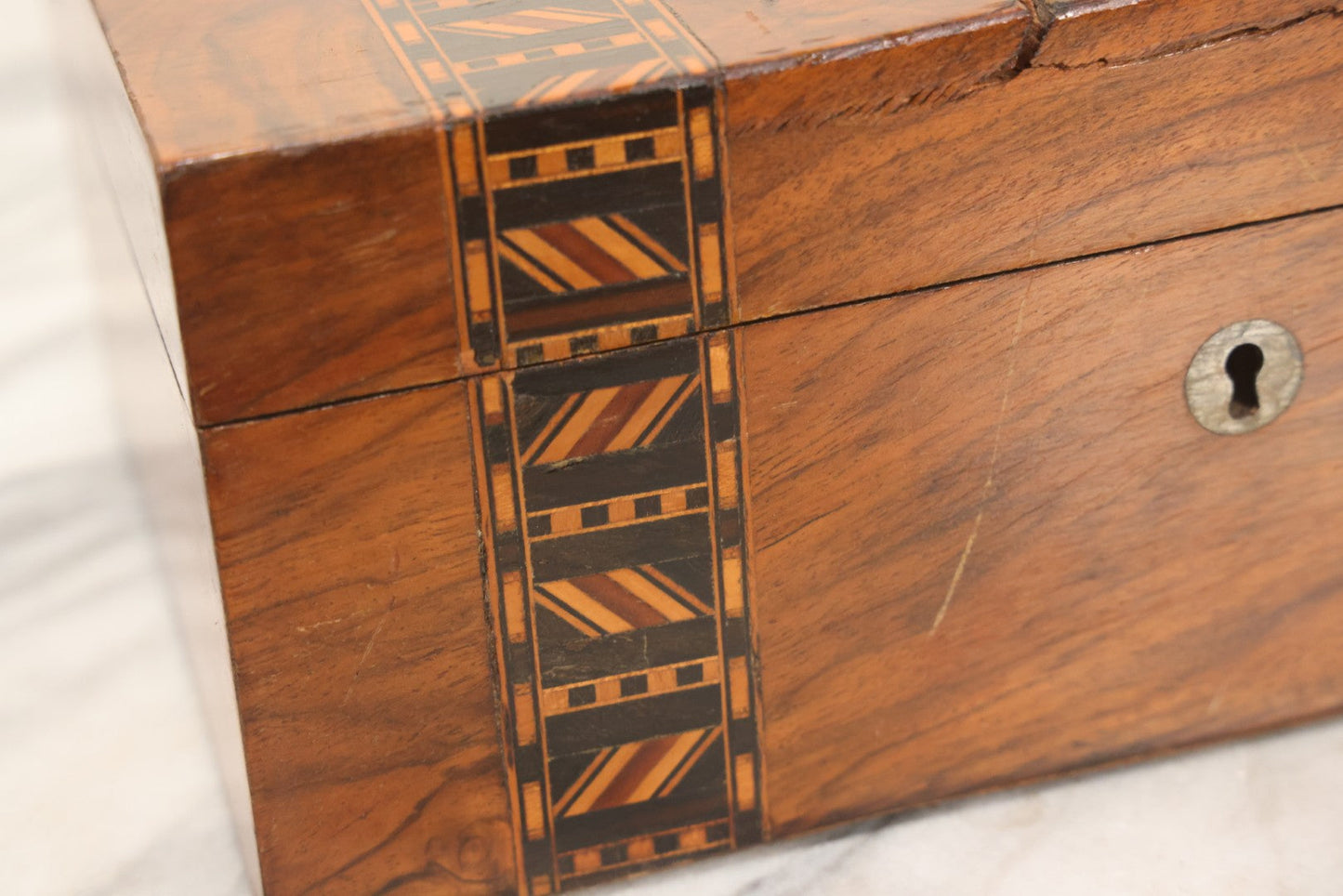 Lot 077 - Antique Burlwood Veneered Wooden Document Box With Inlaid Geometric Patterned Stripes And Center Metal Pendant