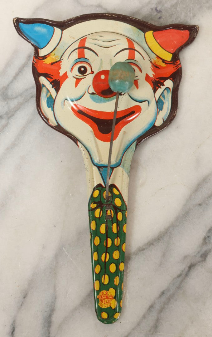 Lot 096 - Vintage Tin Lithograph Horned Clown Noise Maker With Wooden Ball Knockers, U.S. Toy Metal Mfg. Co., Made In USA.