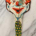 Lot 096 - Vintage Tin Lithograph Horned Clown Noise Maker With Wooden Ball Knockers, U.S. Toy Metal Mfg. Co., Made In USA.