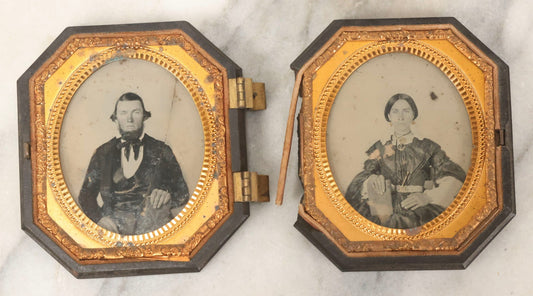 Lot 163 - Pair Of Antique 1/6th Plate Ambrotype Photographs Of Man And Woman Holding Books In Double Sided Thermoplastic Union Case, Note Damage