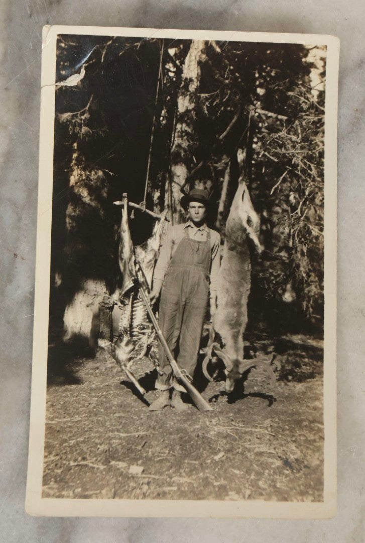 Lot 185 - Grouping Of Six Antique Hunting And Outdoor Photographs Including RPPC Of Young Man With Porcupine Kill At Campsite, Two Snapshots With Deer, Geese, And Gun, And Mounted Winter Photo Of Man With Rabbit, Hubert Soule, Fairfield, Vermont