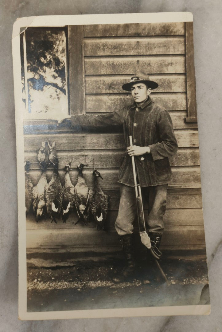 Lot 185 - Grouping Of Six Antique Hunting And Outdoor Photographs Including RPPC Of Young Man With Porcupine Kill At Campsite, Two Snapshots With Deer, Geese, And Gun, And Mounted Winter Photo Of Man With Rabbit, Hubert Soule, Fairfield, Vermont