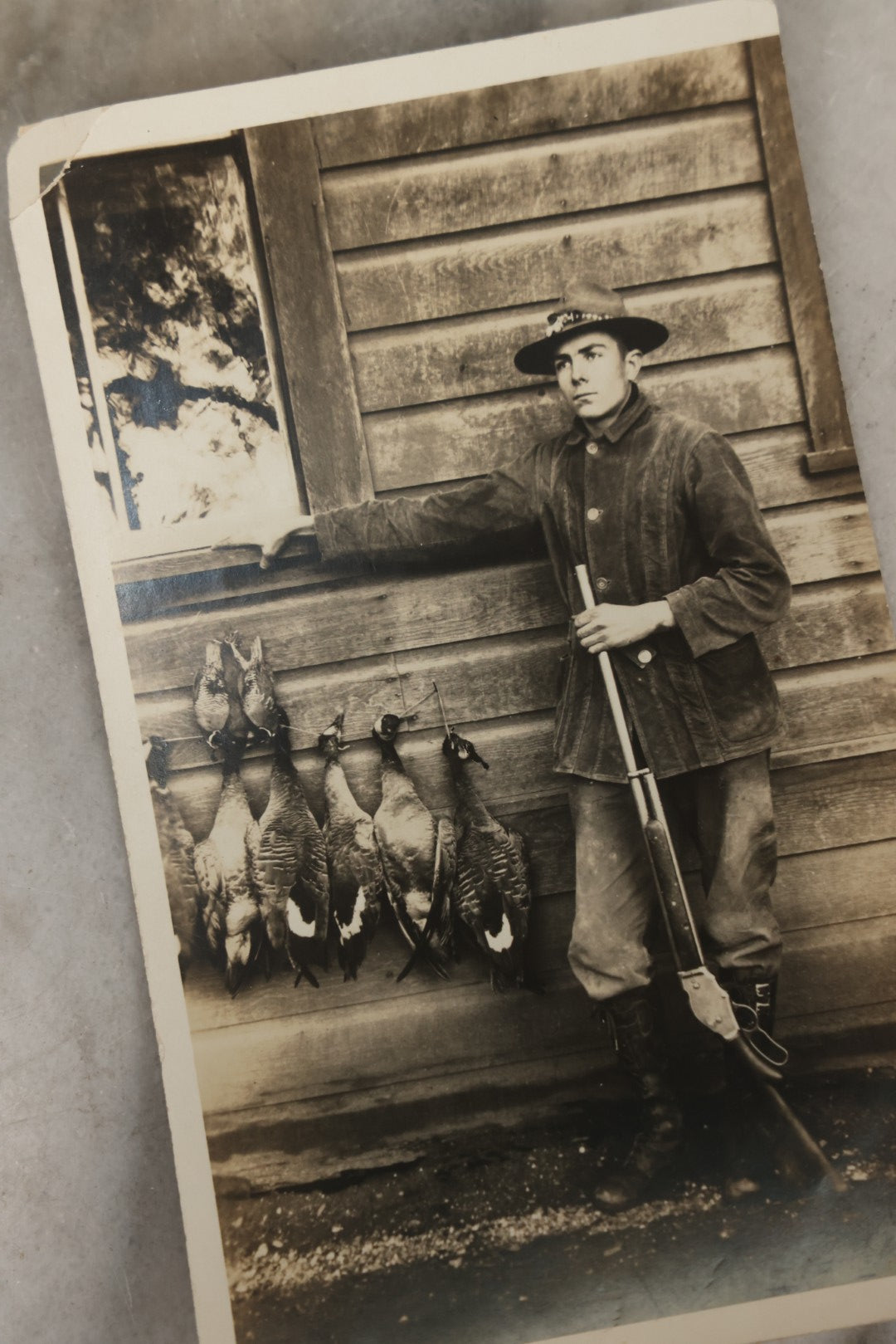 Lot 185 - Grouping Of Six Antique Hunting And Outdoor Photographs Including RPPC Of Young Man With Porcupine Kill At Campsite, Two Snapshots With Deer, Geese, And Gun, And Mounted Winter Photo Of Man With Rabbit, Hubert Soule, Fairfield, Vermont