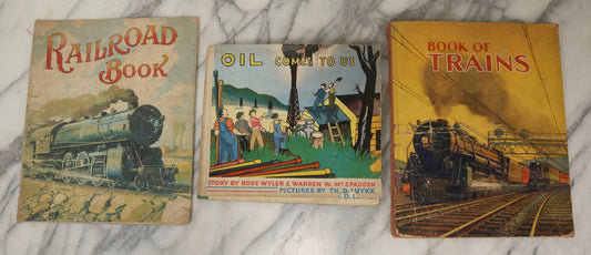 Lot 203 - Grouping Of 3 Antique And Vintage Industrial-Themed Children's Books Including “Railroad Book” By McLoughlin Bros., “Book Of Trains” By Grif Teller, And “Oil Comes To Us” By Rose Wyler And Warren W. McSpadden