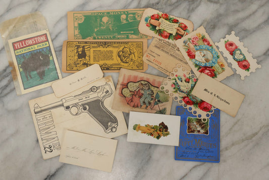 Lot 242 - Grouping Of 15 Antique And Vintage Mixed Ephemera Scraps Including Novelty Space Money From Neptune, 1882 Award Of Merit, Hand Motif Calling Cards, New England Jewelry Co. Coupon, Cat Booklet, Yellowstone Decal, And Erma EP22 Pistol Booklet