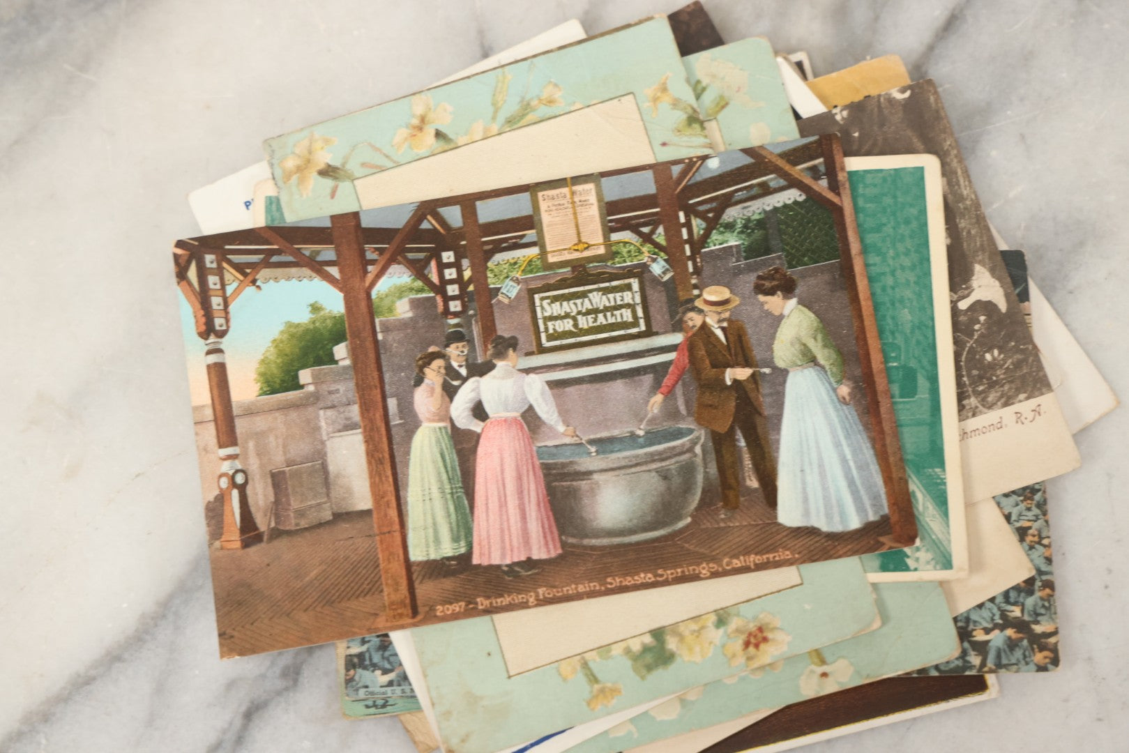 Lot 243 - Grouping Of 15 Antique And Vintage Postcards Including Fisk Tires And Shasta Water Advertising, Douglas Fairbanks Movie Promotion, Early Reno Undivided Back, Mythological Subjects, And Wwii Comic Cards