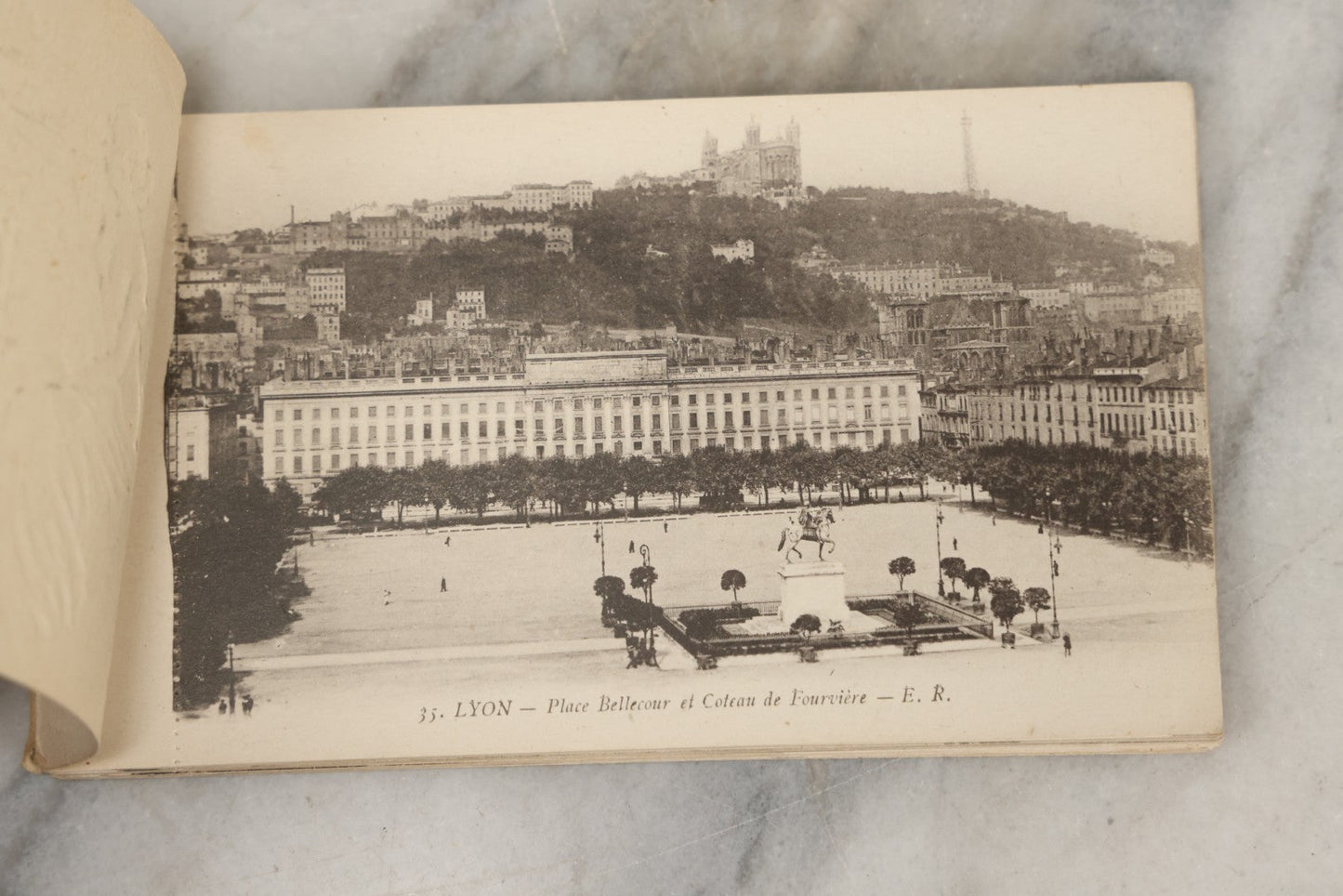 Lot 252 - Antique Souvenir Postcard Album “Album-Souvenir” With Embossed Gilt Cover Nude Woman On Globe, Containing Twenty Perforated Postcards Of Lyon, France