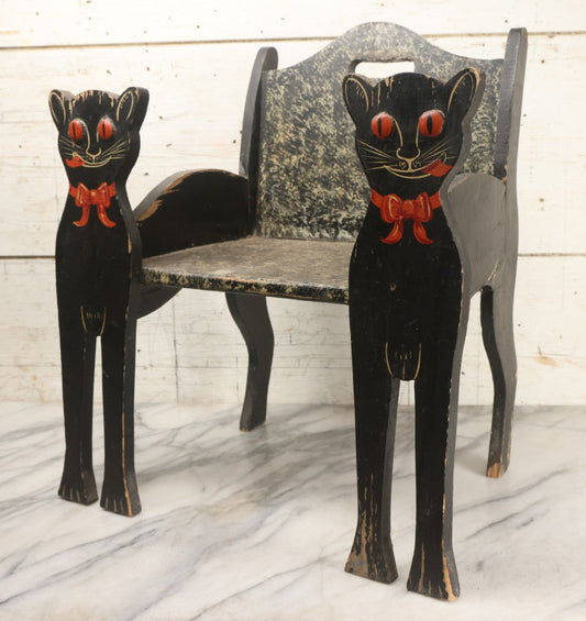Lot 001 - Vintage Folk Art Wooden Black Cat Child's Seat With Red Bow Ties And Domed Eyes, Hand Painted With Sponge Painted Texture Finish, Circa 1930s