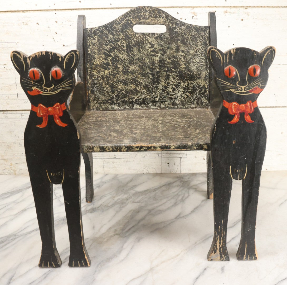 Lot 001 - Vintage Folk Art Wooden Black Cat Child's Seat With Red Bow Ties And Domed Eyes, Hand Painted With Sponge Painted Texture Finish, Circa 1930s