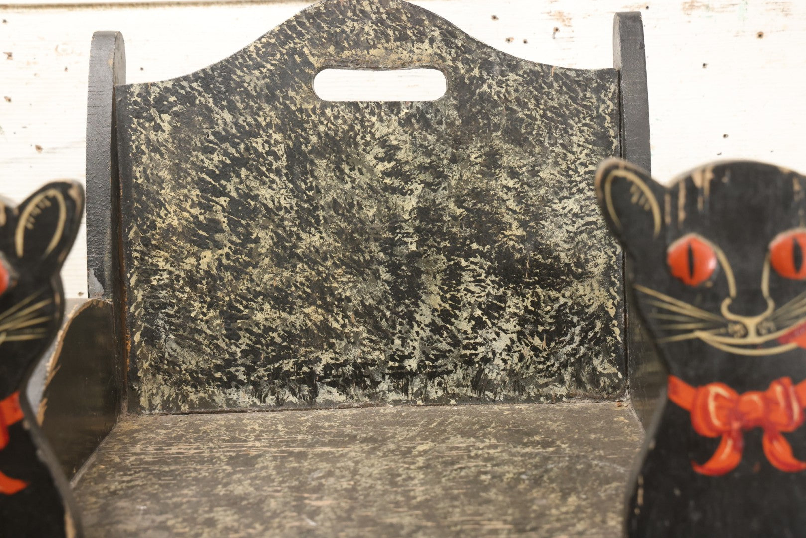 Lot 001 - Vintage Folk Art Wooden Black Cat Child's Seat With Red Bow Ties And Domed Eyes, Hand Painted With Sponge Painted Texture Finish, Circa 1930s