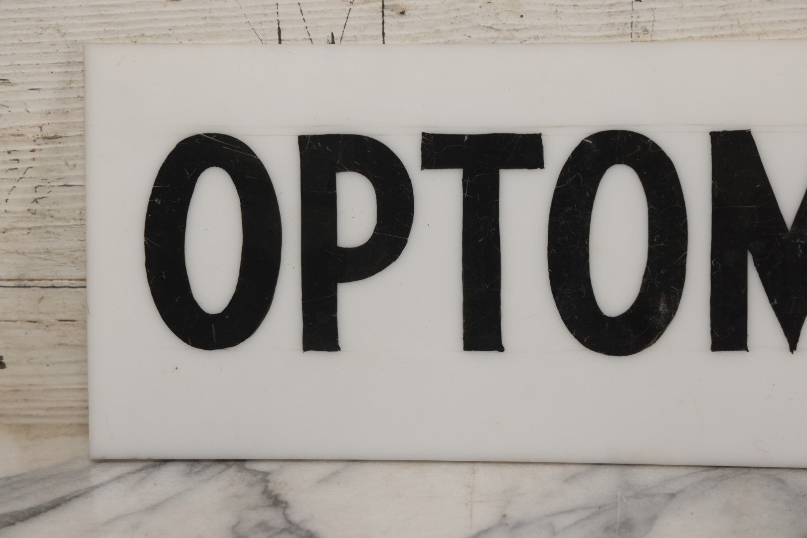 Lot 011 - Vintage Hand-Painted "Optometrist" Trade Sign On White Plexiglass, 23-1/2" x 6"