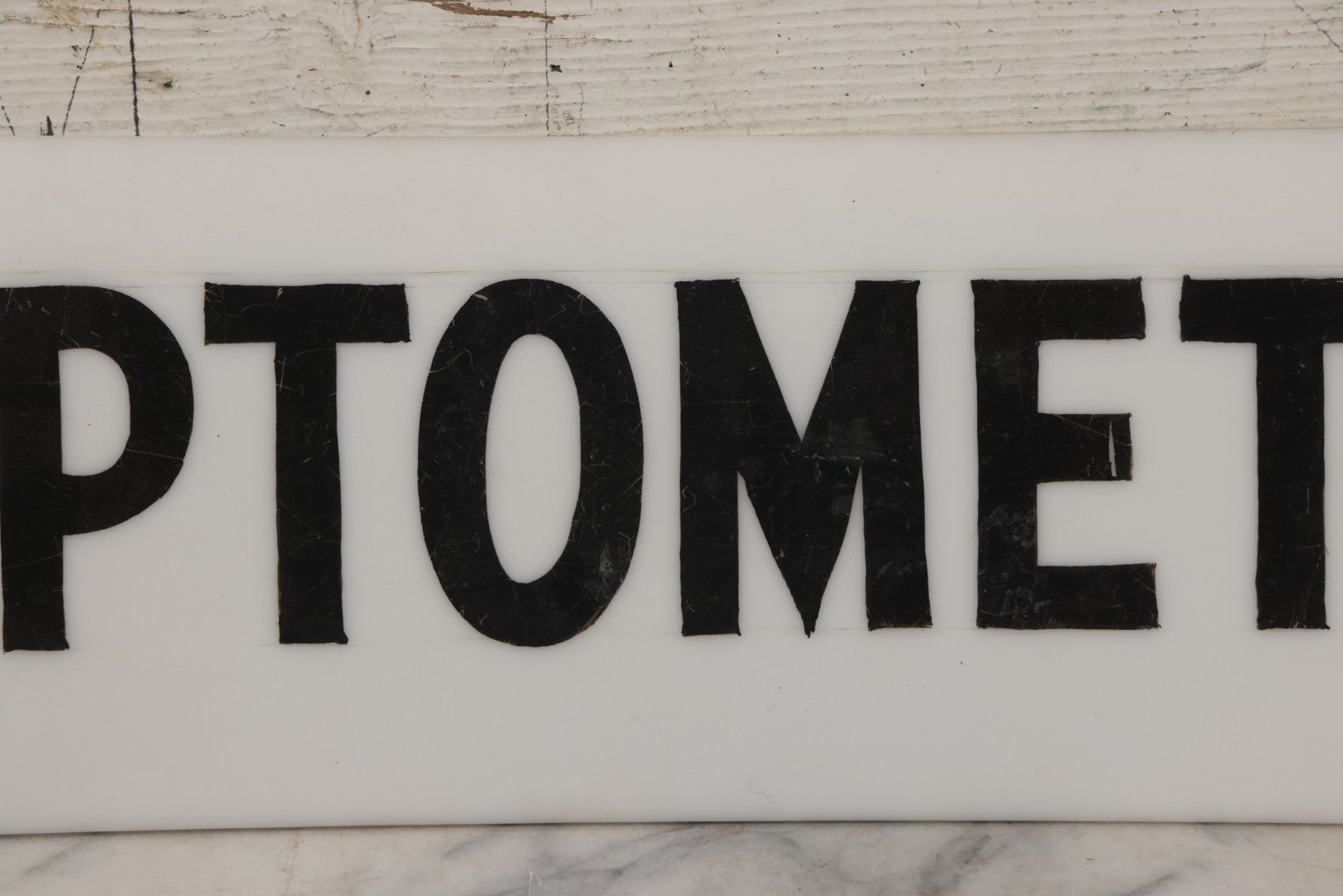 Lot 011 - Vintage Hand-Painted "Optometrist" Trade Sign On White Plexiglass, 23-1/2" x 6"