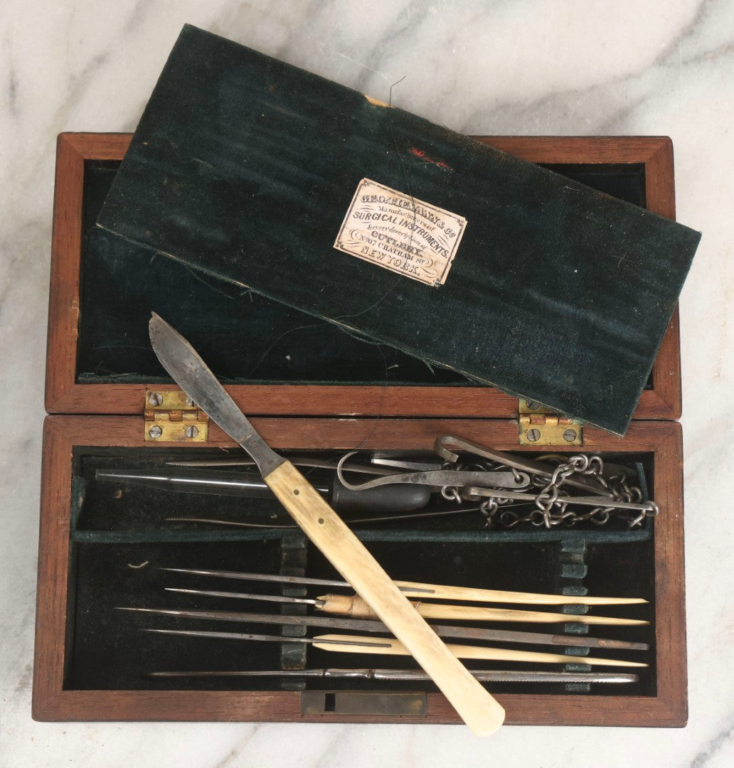 Lot 012 - Antique Surgical Implement Kit By George Tiemann & Co., New York, With 12 Implements Including Bone Handle Tools And Triple Chain Dissection Hook, In Original Box With Paper Label, Circa 1860s