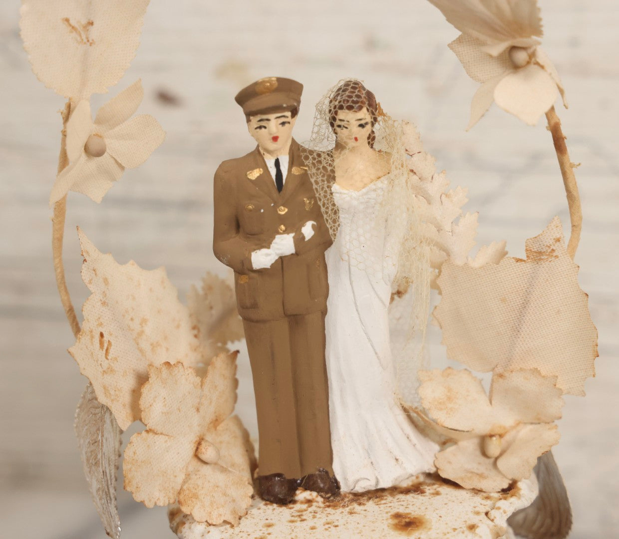 Lot 035 - Vintage Wwii Era Servicemember Wedding Cake Topper In Glass Dome Cloche With Bride, Groom In Military Uniform, Faux White Flowers, And Wood Base, 9-1/2" H