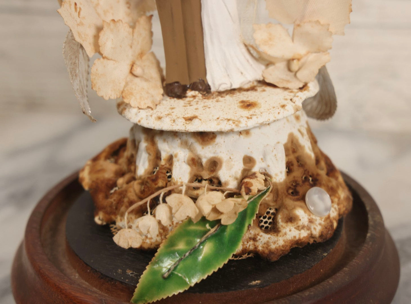 Lot 035 - Vintage Wwii Era Servicemember Wedding Cake Topper In Glass Dome Cloche With Bride, Groom In Military Uniform, Faux White Flowers, And Wood Base, 9-1/2" H