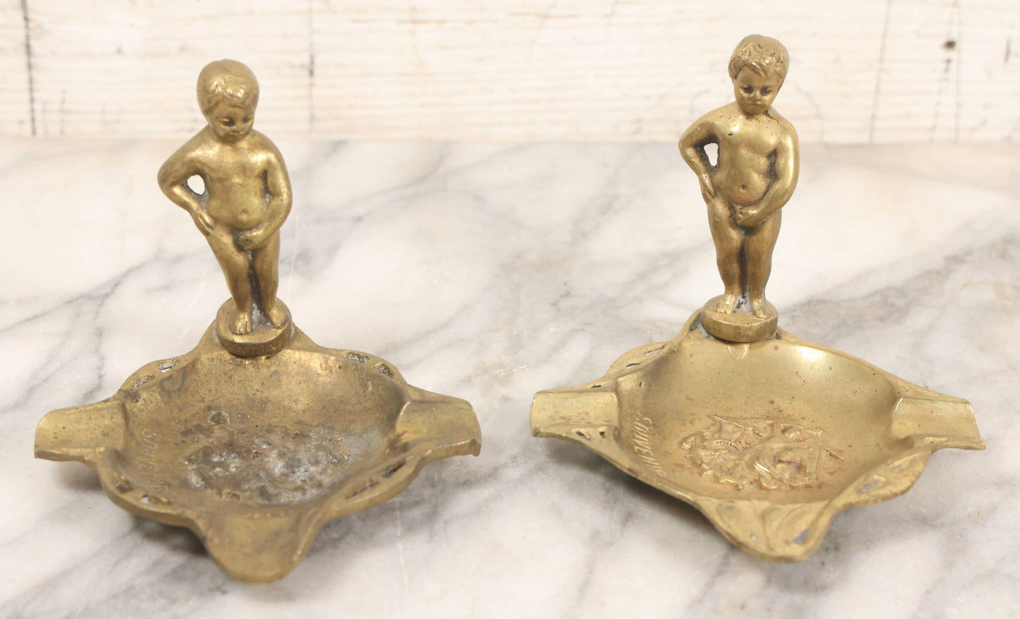Lot 050 - Pair Of Vintage Cast Bronze "Souvenir De Bruxelles" Boy Ashtrays With Winged Herald And Dragon Motif, 3-5/8" H Each