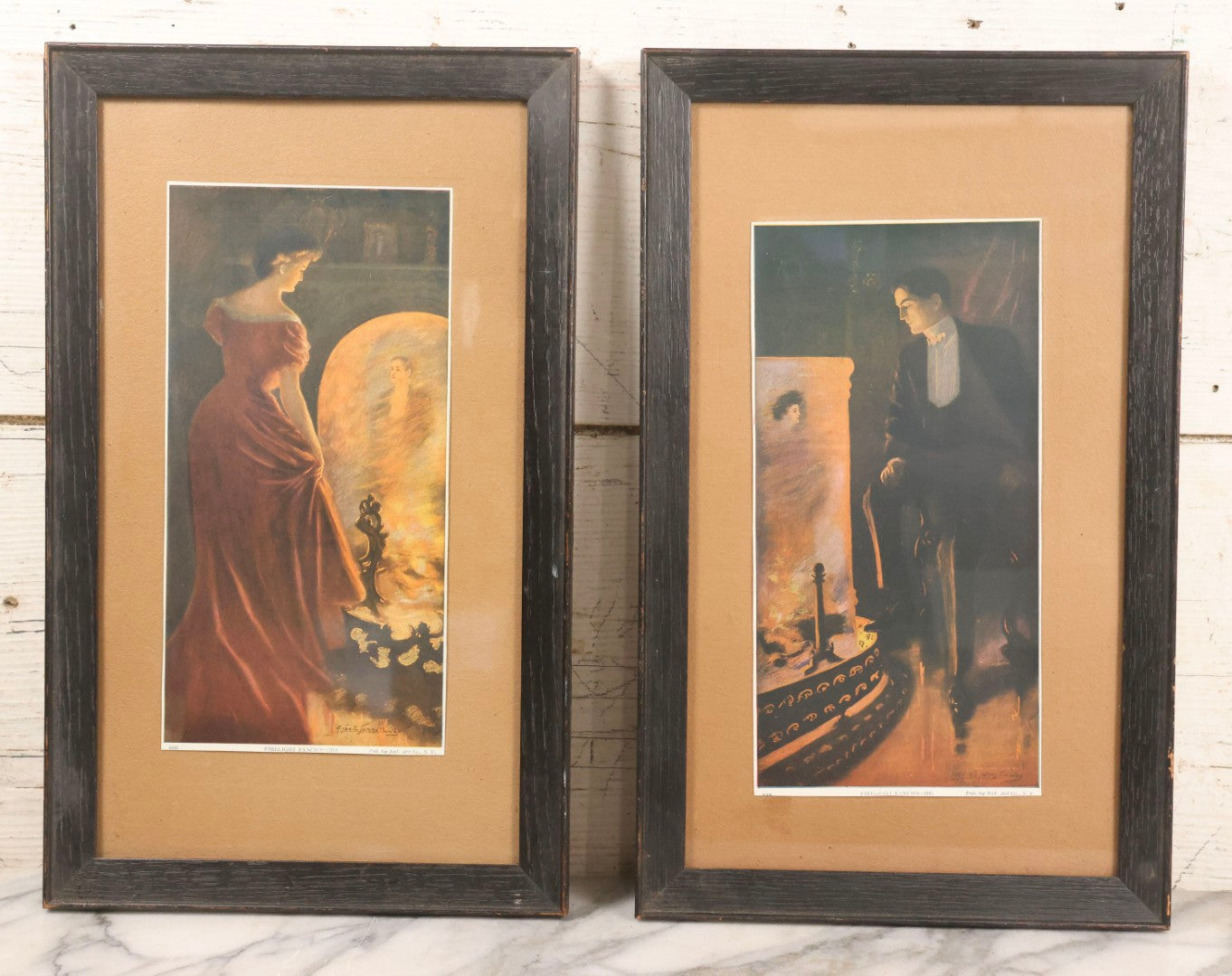 Lot 057 - Pair Of Antique Framed Prints "Firelight Fancies He" And "Firelight Fancies She" By Alfred James Dewey, National Art Co., New York, 1908, 9-1/2" x 15-3/8" Each