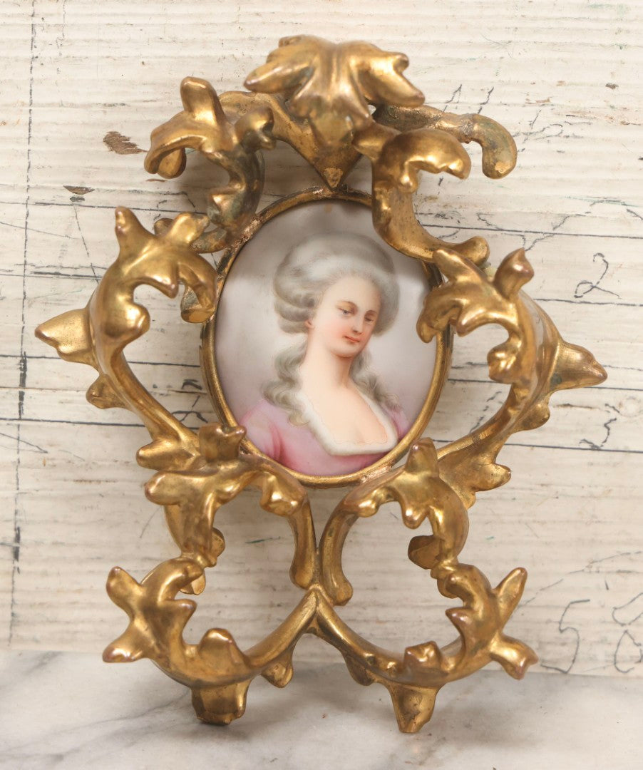 Lot 076 - Antique Hand Painted Porcelain Tile Of White-Haired Woman In Pink Dress In Ornate Ormolu Frame, A.M.W., 24Kt Gold Plate, Note Frame Damage, Repairs, 4-3/4" x 5-3/4"