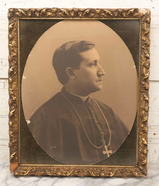Lot 103 - Antique Oval Black And White Photograph Of Priest In Vestments With Pectoral Crucifix, Circa 1920s In Gilded Moulded Gesso Frame, 13" x 15-3/8"